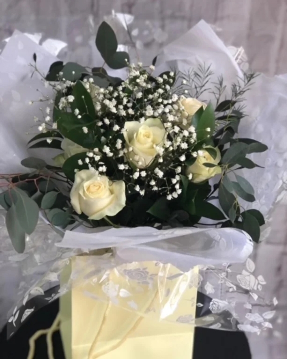 White roses in gift bag